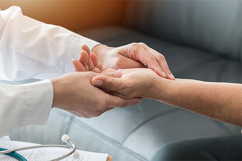 Holding HIV patient's hands